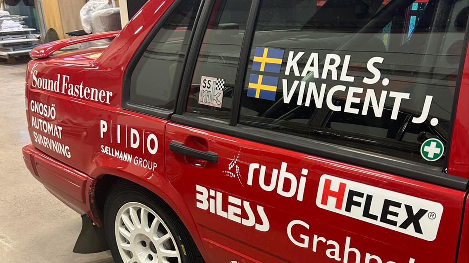 The rally car is adorned with sponsor logos – including Sound Fastener, proudly displayed along the bodywork.